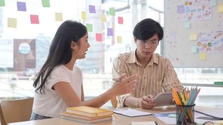 Young creative people are working, discussing ideas for new strategy of development together.