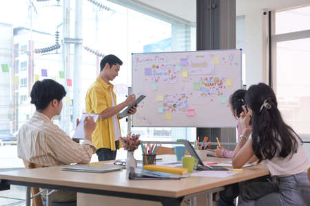 Successful business team joining fists each other, showing support and celebrating corporate...