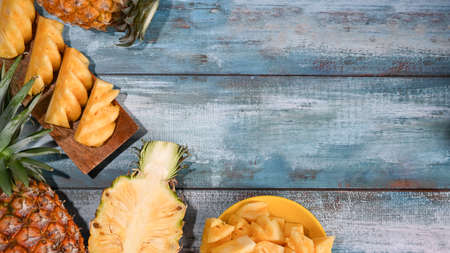 Ripe sliced pineapple on wooden background with copy space. Summer, tropical fruit concept.の写真素材