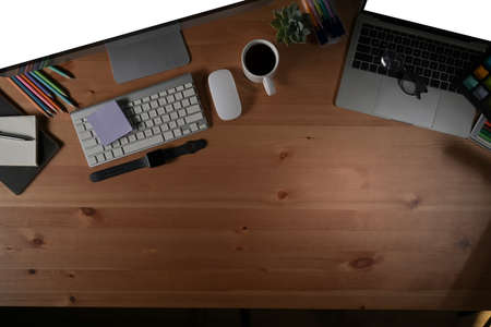 Above view home office desk with computer, coffee cup and supplies.