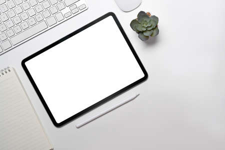 Mock up digital tablet, notepad, stylus pen and wireless on white office desk.