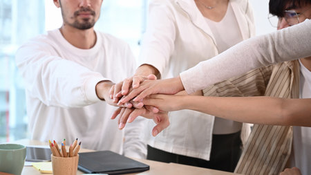 Shot of young businesspeople joining fists each other, showing support and team spirit together,...