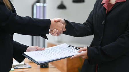 Cropped shot business partner shaking hands after finishing up a meeting or investment deal. Concept of teamwork and partnership.の写真素材