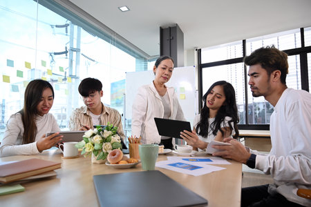 Diverse executive managers discussing new project strategy and working together at modern office.