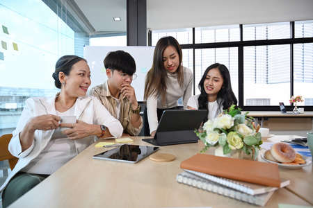 Group of successful business people brainstorming, discussing new project strategy together at...