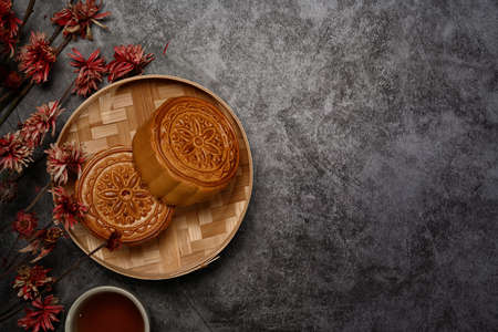 Chinese traditional mid autumn festival moon cake on rustic black background with copy space.の写真素材