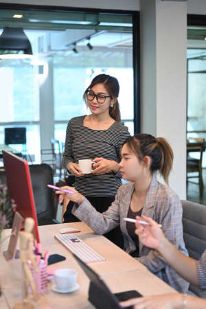 Team of software developers working together for developing website design and coding technologies at company.の写真素材