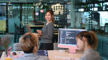 Young programmers or software developers team brainstorming, discussing on web site project together.の写真素材