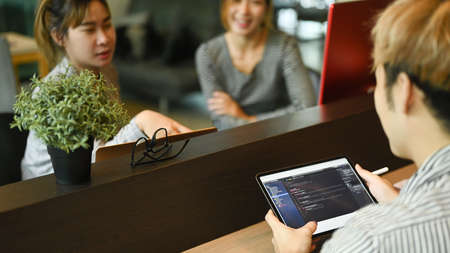Software engineer and coding programmer working on new project together at co working space.
