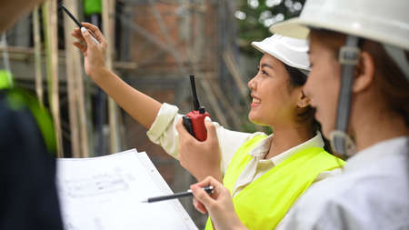 Cropped imaged of female architects are supervising progress of construction project together....