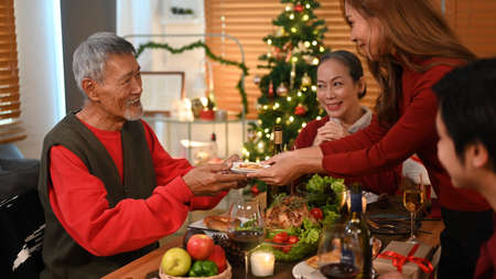 Joyful family having Christmas dinner in cozy room. Christmas and thanksgiving concept.