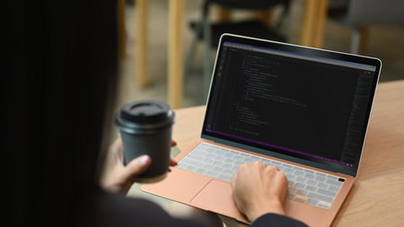 Close up view of software developer working on web site project, programming on desktop computer in...
