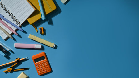 Various school supplies on a blue background with copy space ready for your design. Top view, Flat lay.の写真素材