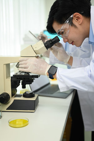 Professional scientists team conducting experiment in modern laboratory. Medicine and science...