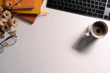 Simple workplace with keyboard, coffee cup, glasses and notebook. Flat lay, Top view.の写真素材