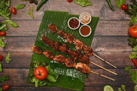 Delicious grilled meat with Sichuan pepper on banana leaf. Mala Chinese BBQ is meat or vegetable grilled with Chinese hot and spicy spices.の写真素材
