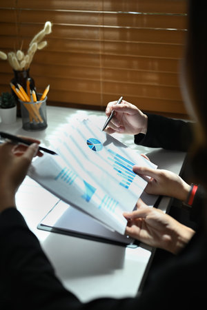 Cropped shot of business people analyzing financial graph, discussing business strategy at meeting.の写真素材