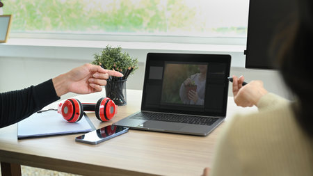 Cropped shot of creative retouchers team editing digital photos, collaborating on new project...