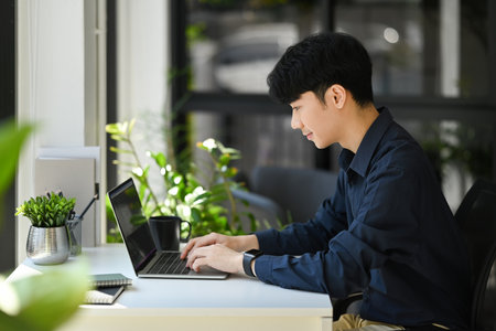 Focused male programmer or coder working for development website design in startup company.