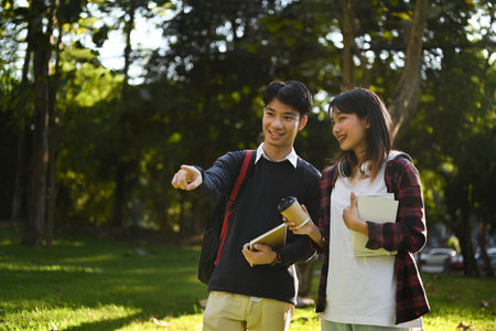 Shot of asian student walking in campus and talking to each other about exam results.の写真素材