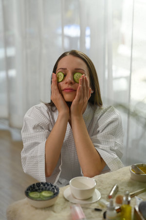 Caucasian woman in bathrobe making daily beauty routine at home. Beauty treatment and self care...