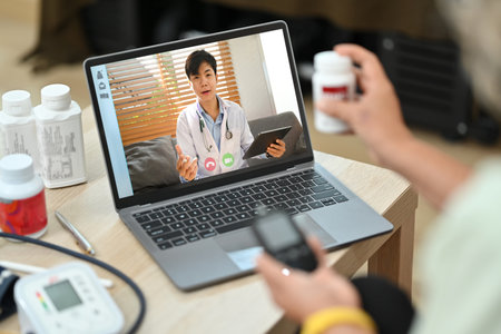 Cropped shot of elderly woman having online consultation with doctor on laptop. Therapist online, telemedicine concept.の写真素材