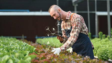 Farmer using modern technology in agricultural production planning and preparation. Smart agriculture and technology concept.の写真素材