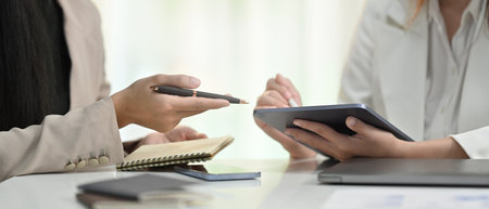 Cropped shot of business colleagues shearing idea, discussing corporate business plan together at...