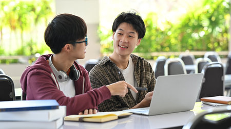 University students using laptop, working together on academic project. Education, Learning and community.の写真素材