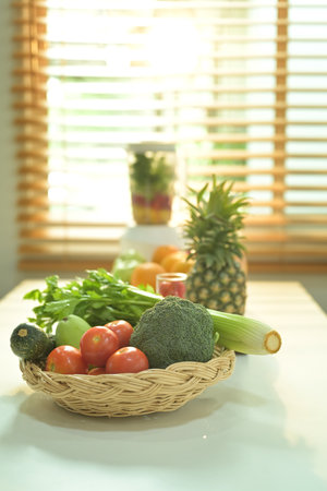 Assorted fruits in wicker basket with blender on background. Healthy food and vegetarian concept.の写真素材