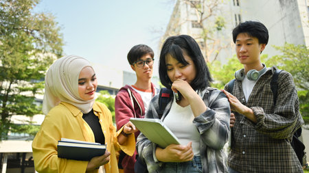 Caring group of university students comforting sad female friend. Friendship, support and youth lifestyle concept.の写真素材