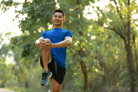 Handsome sportsman stretching his muscular before running in the morning. Fitness, sport and healthy...