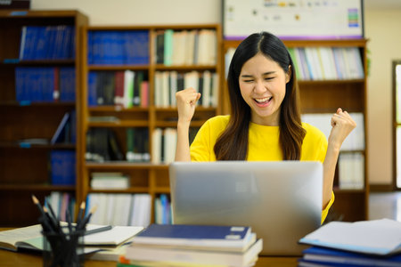 Excited happy student woman looking at laptop reading great news, passed exam, received university...