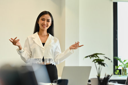 Shot of millennial businesswoman giving presenting sales report, marketing strategy, project plan at corporate meeting.の写真素材