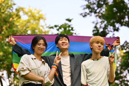 Group of young activist with pride rainbow flag in their backs supporting LGBTQ community and shooting of equality social.の写真素材