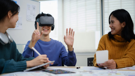 Team of developers is brainstorming, testing virtual reality simulator glasses at meeting, future...