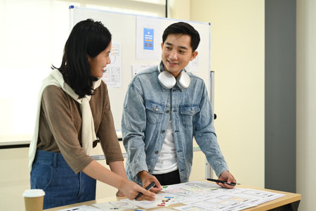 Creative business colleagues brainstorming, sharing idea for startup project in co working office space.の写真素材