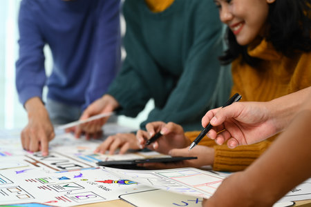 Mobile application designers brainstorming, working on design project in creative office.の写真素材