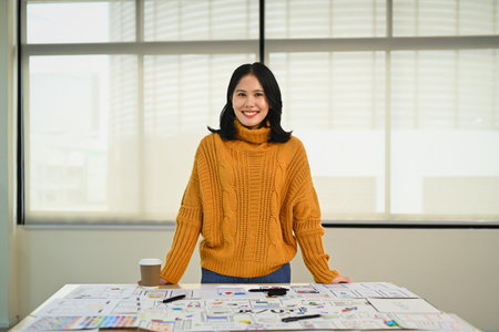 Portrait of web developer woman working on app design and user interface at workstation.の写真素材