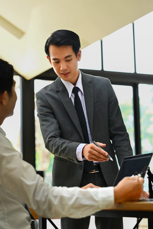 Shot of businessman explaining information, talking about company strategy and business plan during meeting.の写真素材