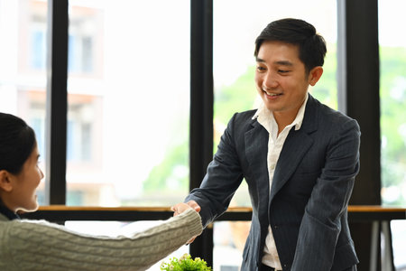 Businesspeople shaking hands closing deal or after successful negotiations at meeting.の写真素材