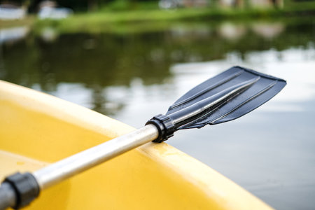 A small yellow boat boat with paddle floating on calm water sunrise. Solitude, calmness and relaxation.の写真素材
