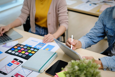 Group of young creative people working on new website wireframe, planning application development at office..の写真素材