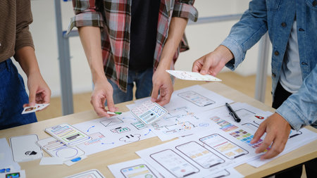 Group of young creative people working on new website wireframe, planning application development at office..の写真素材