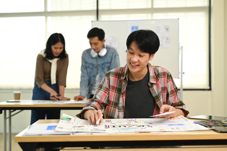 Young male application developers working on new website wireframe, planning application development at creative office.の写真素材