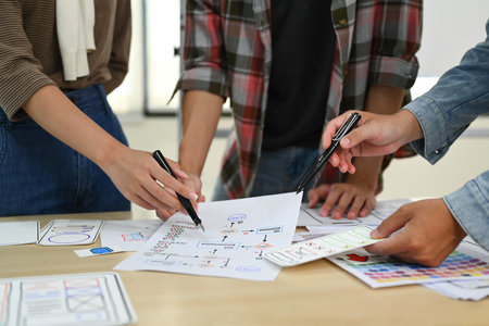 Developer team working on development project for mobile application at creative office. User experience concept.の写真素材