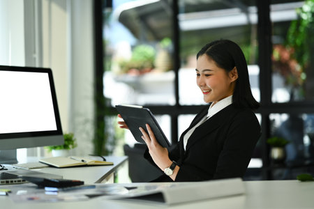 Beautiful asian woman entrepreneur working on investment and marketing projects at modern office.の写真素材