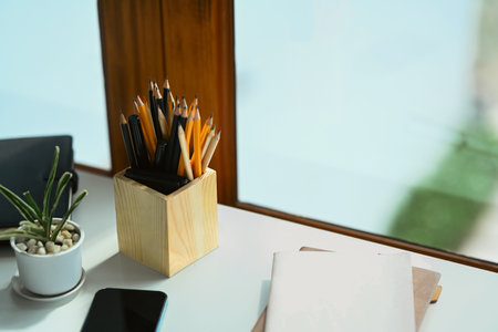 Pencil on pencil holder on office desk with closeup shot..
