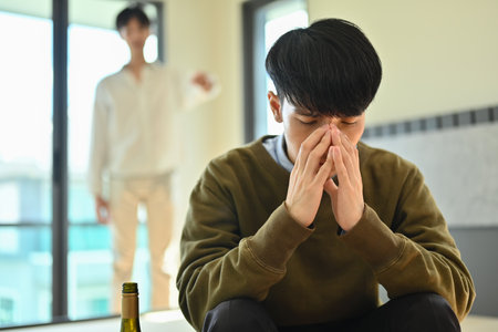 Depressed asian man alcoholic having problem suffer from alcohol addiction abuse.の写真素材