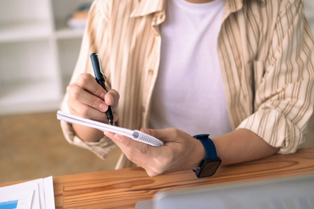 Cropped shot of young businessman writing startup business ideas or important things on notebook.